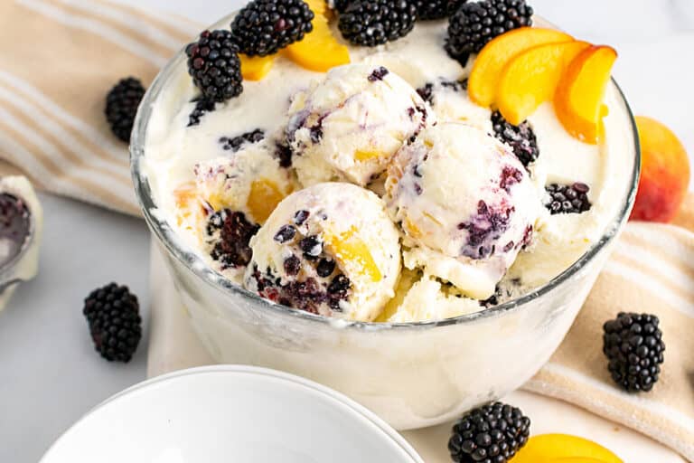 A bowl of peach and blackberry ice cream.