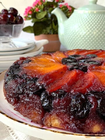 Apricot cake with cherries and a green teapot.
