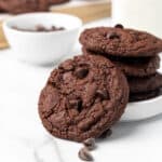 A stack of chocolate chip cookies on a white board