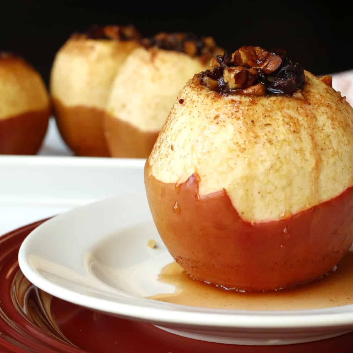 A white plate with a baked apple.