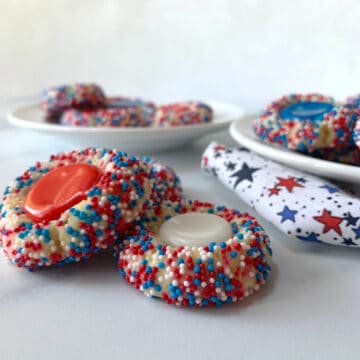 Red, white and Blue Thumbprint Cookies on white plates.
