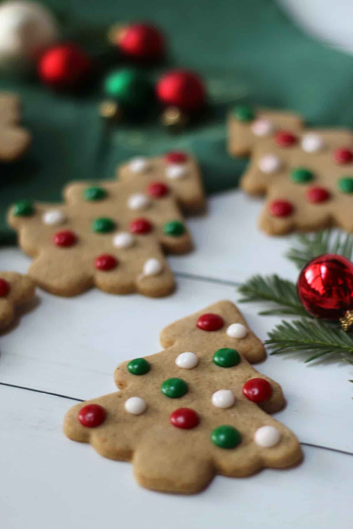 Christree cutout cookies with red, white and green icing dots.