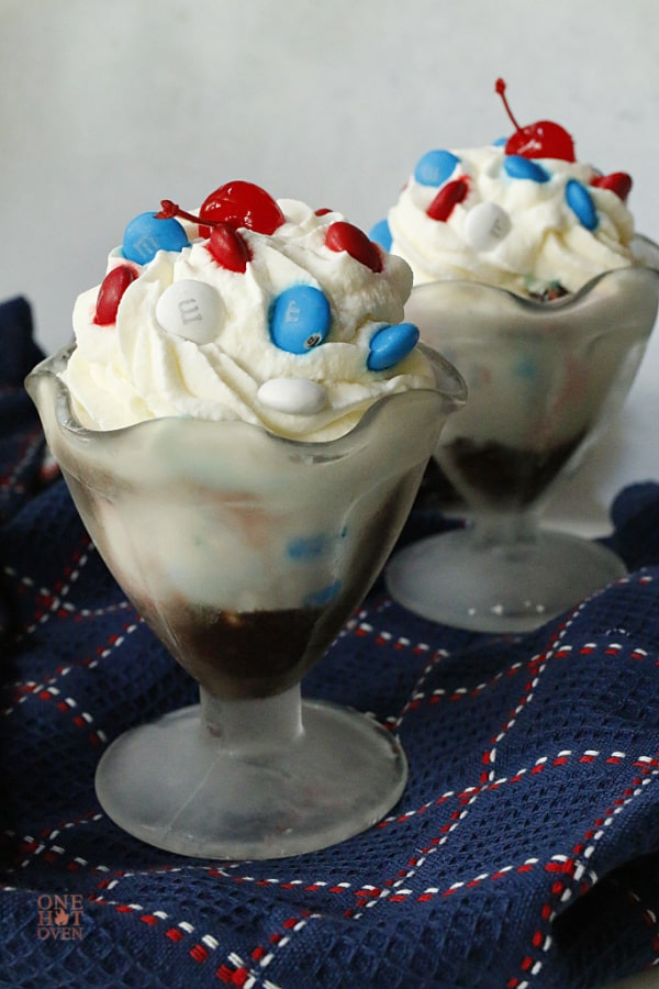 Glasses of ice cream sundaes with whipped cream and m and ms
