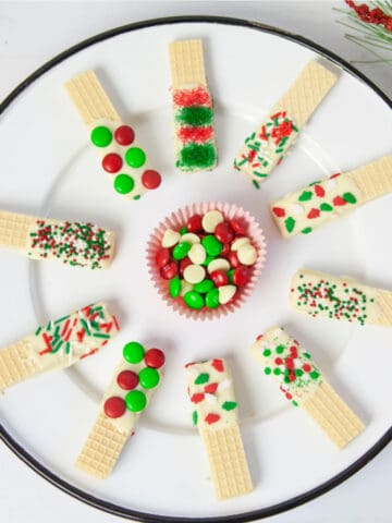 Christmas wafer cookies on a white plate.