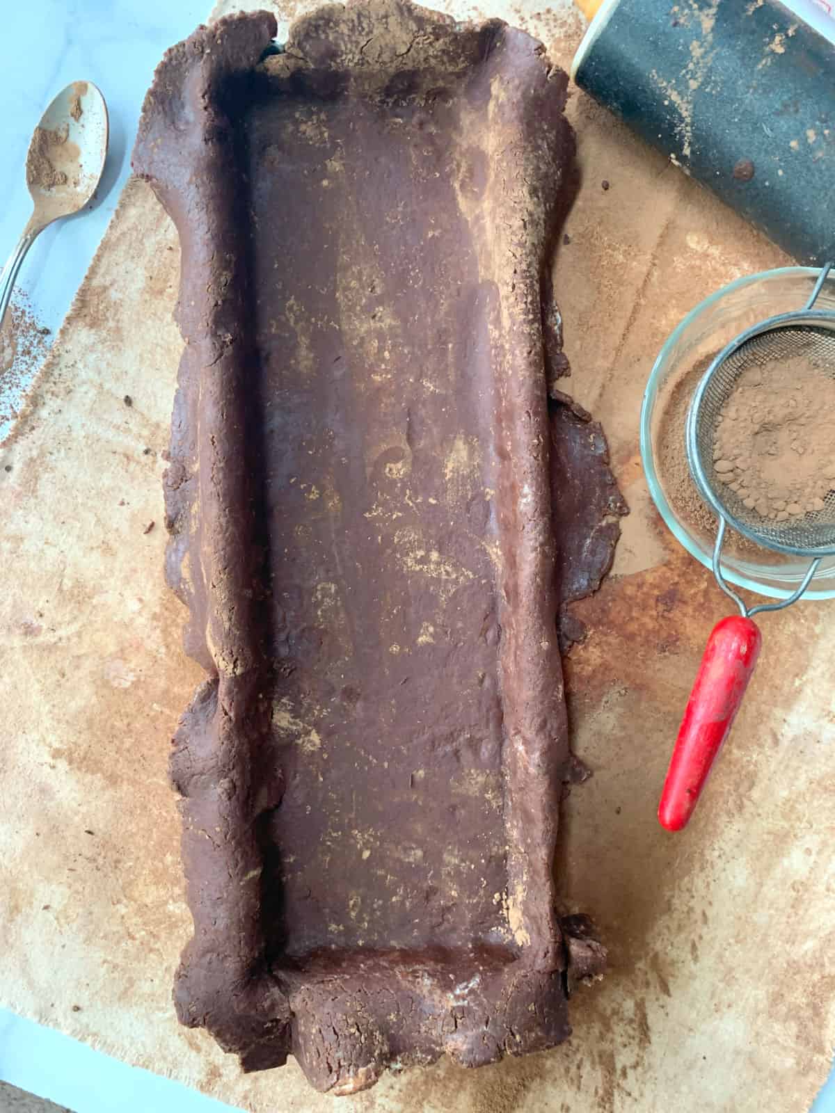 Chocolate dough in a tart pan.