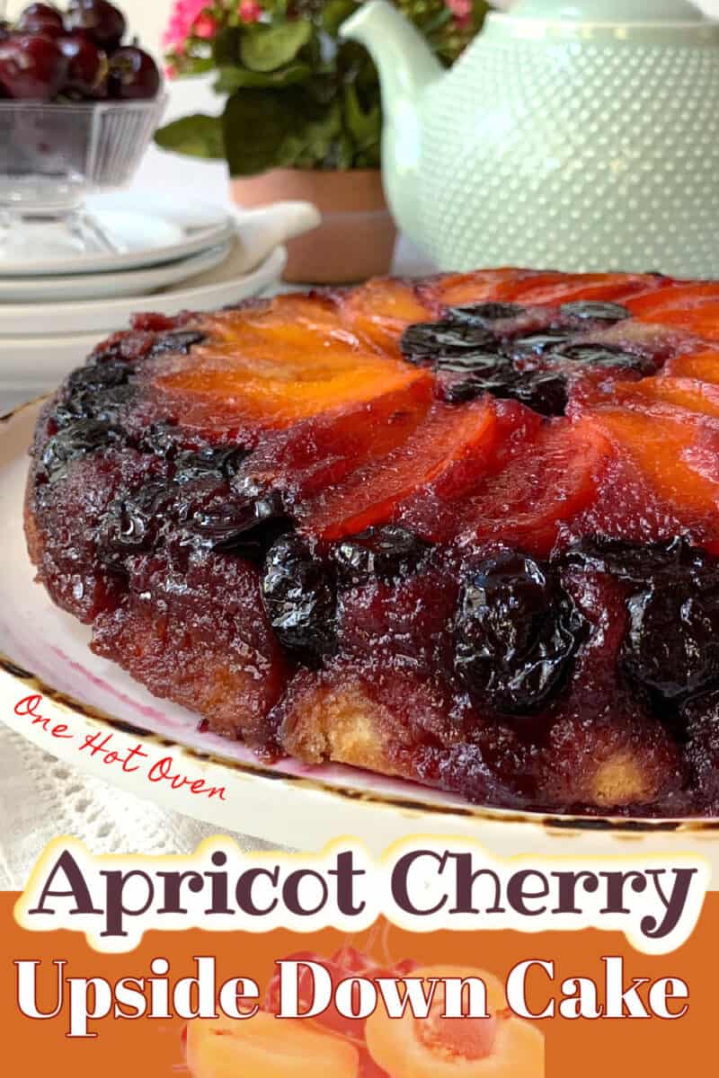 Cherry cake with apricots on a white platter.