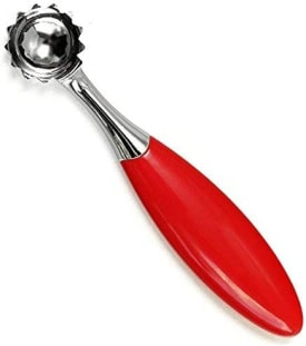 Strawberry huller with a red handle.