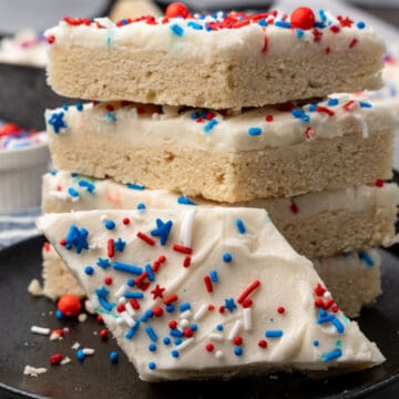Sugar cookies with white frosting and patriotic sprinkles