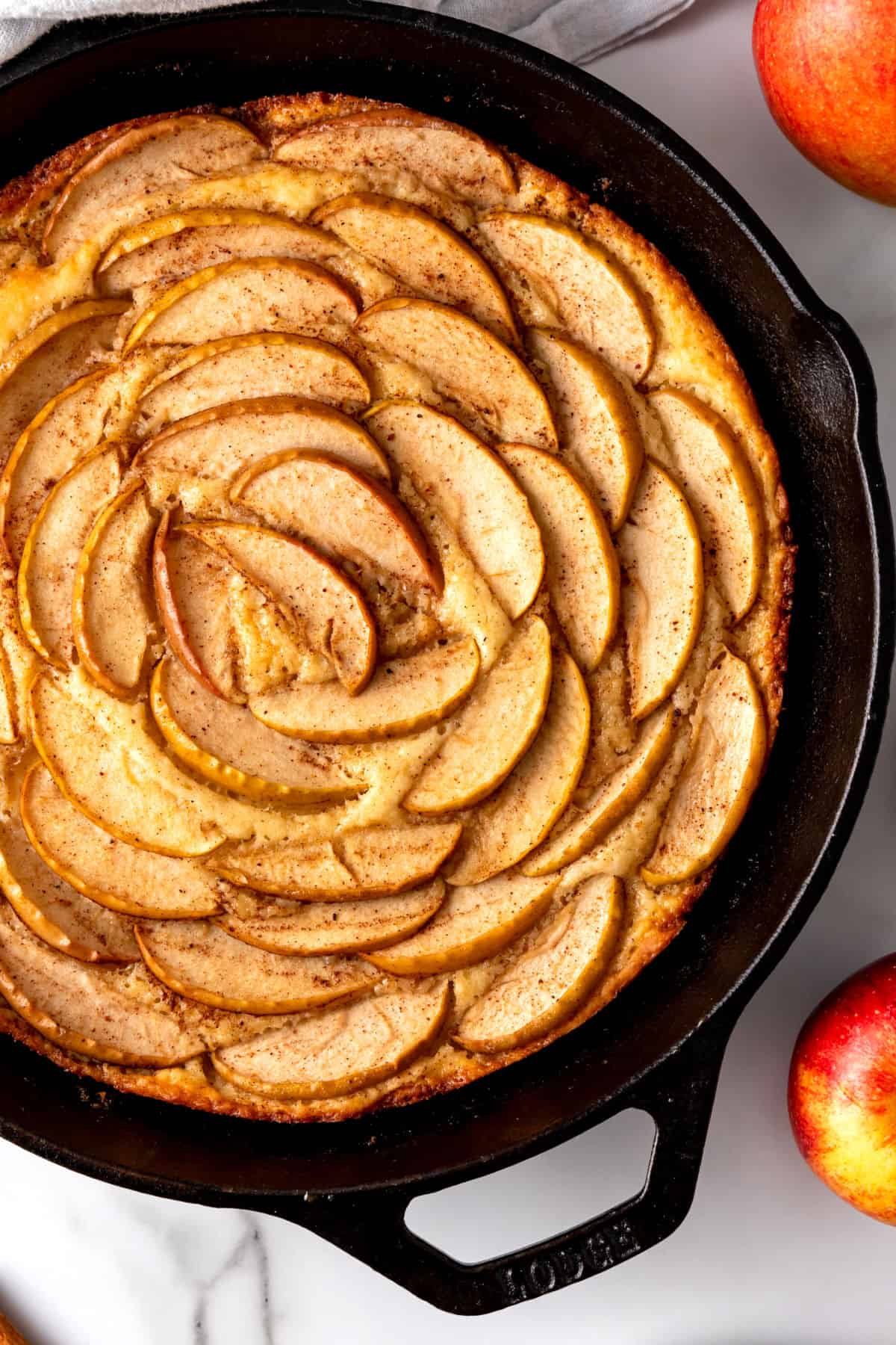 A baked maple apple cake in a cast-iron skillet.