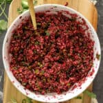 Cranberry jalapeno salsa dip in a white bowl.
