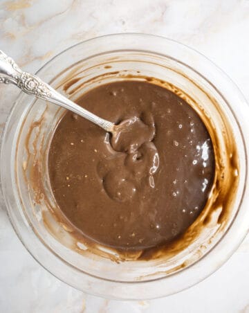 Creamy chocolate and milk in a clear bowl.