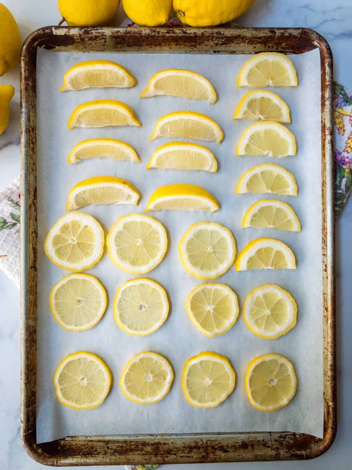 Sliced lemons on a cookie sheet.