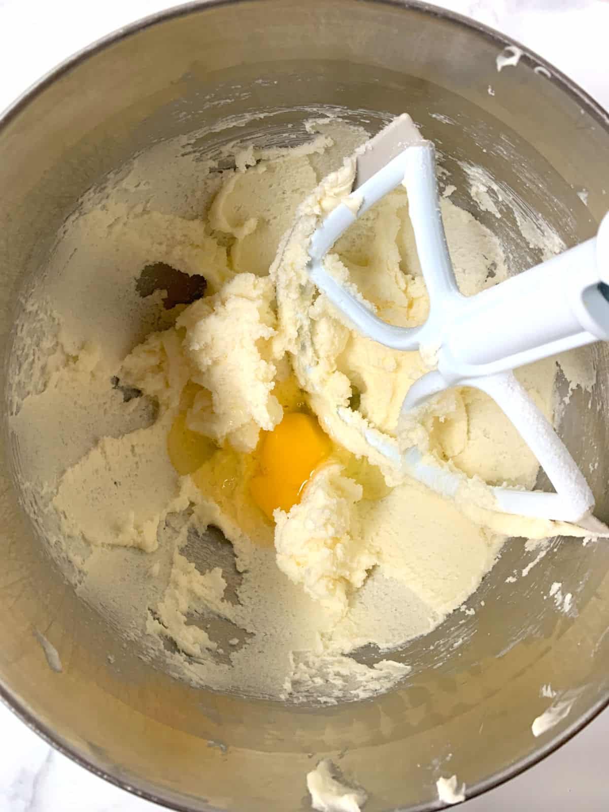 Mixing an egg into a cake batter.