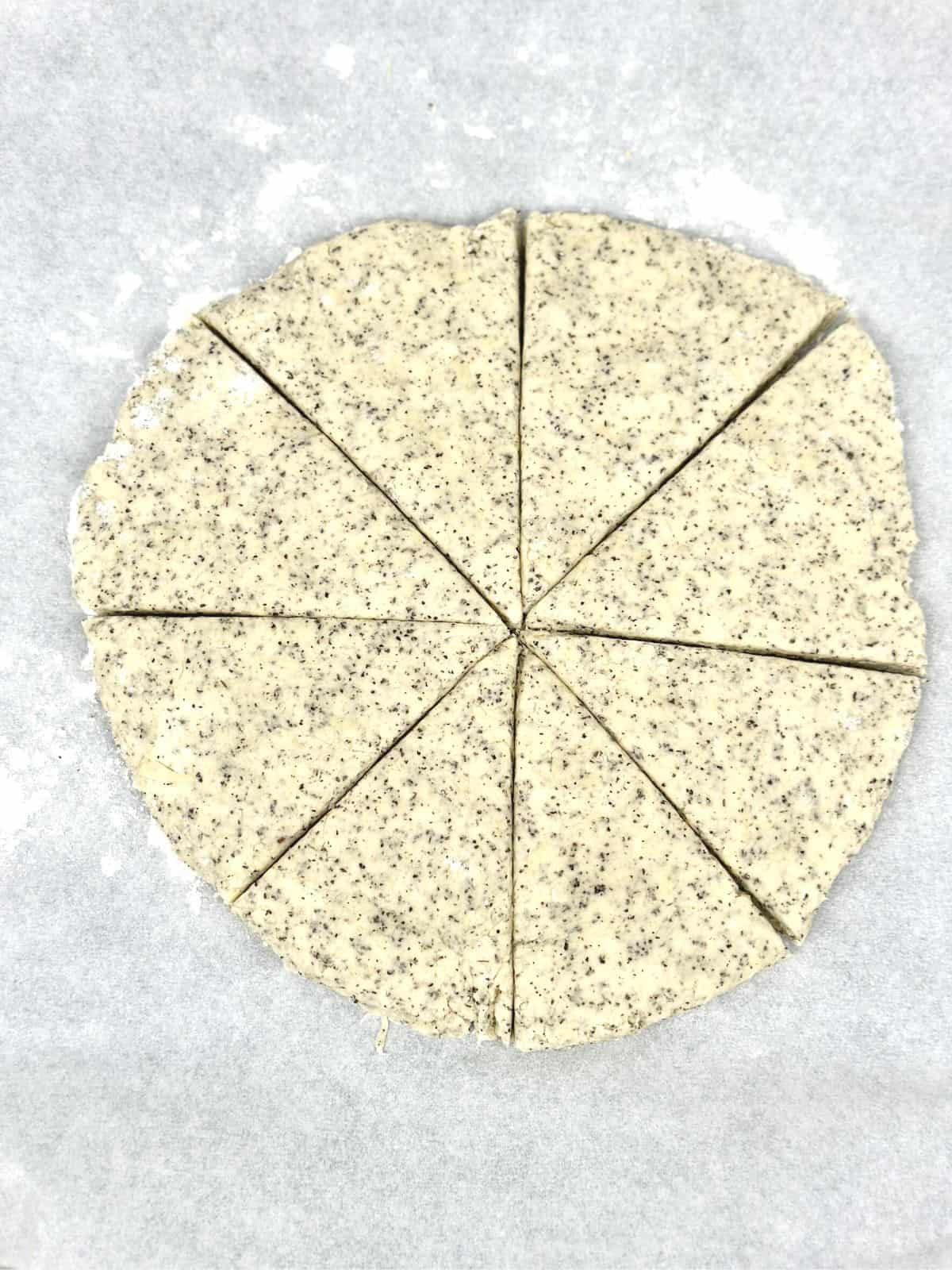A disk of scone dough on a floured board.