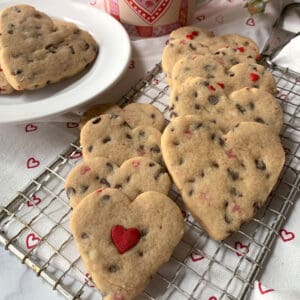 Chocolate chip heart cookies on a wire rack.