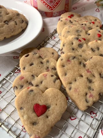 Chocolate chip heart cookies on a wire rack.