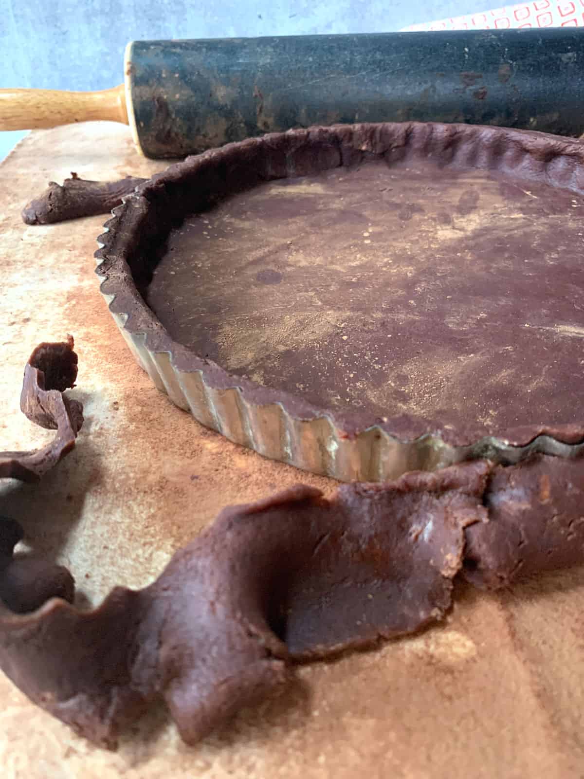 Chocolate pie dough in a tart pan.