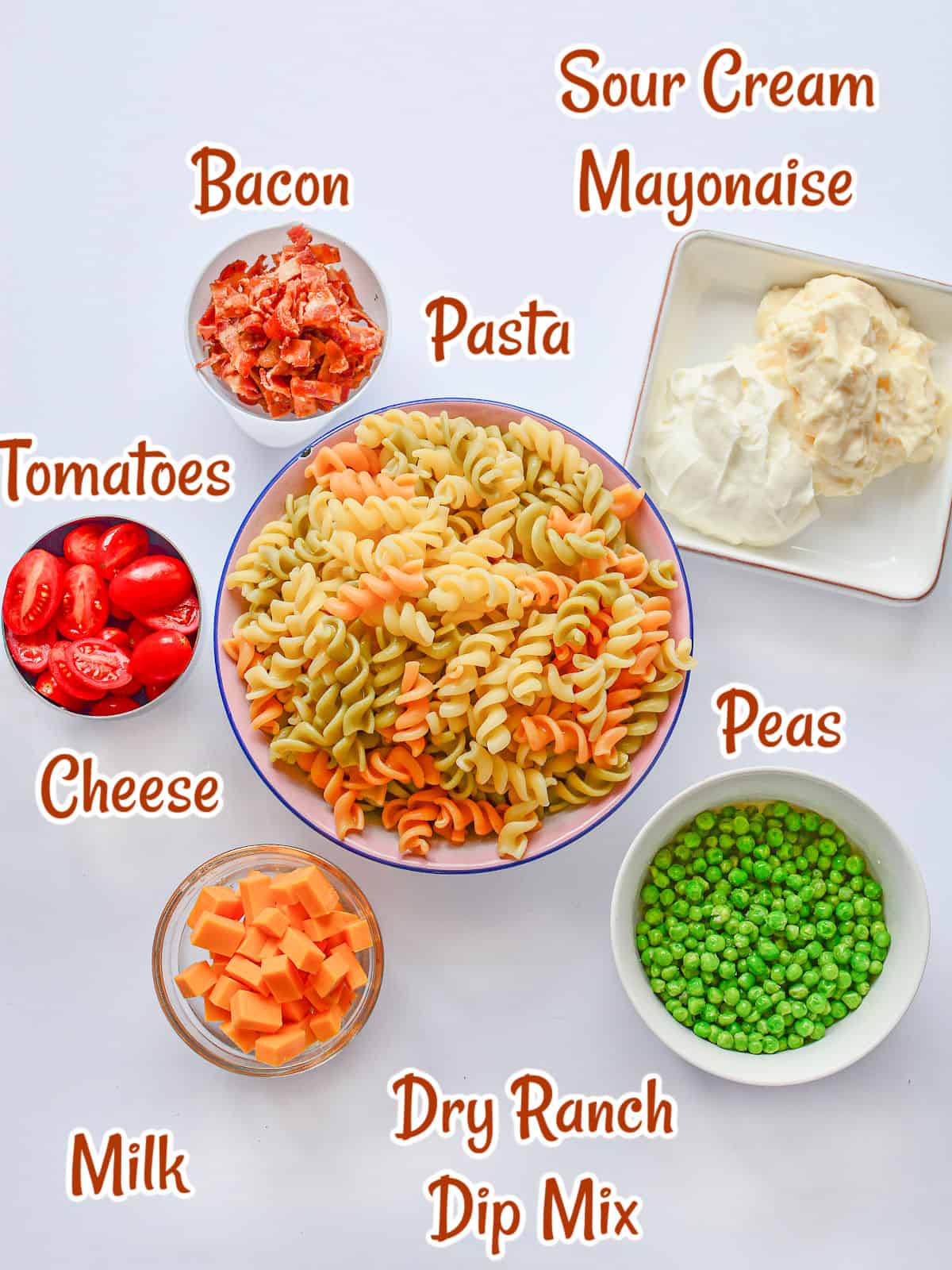 Ingredients for a pasta salad, peas, cheese, pasta, mayonnaise, and bacon.