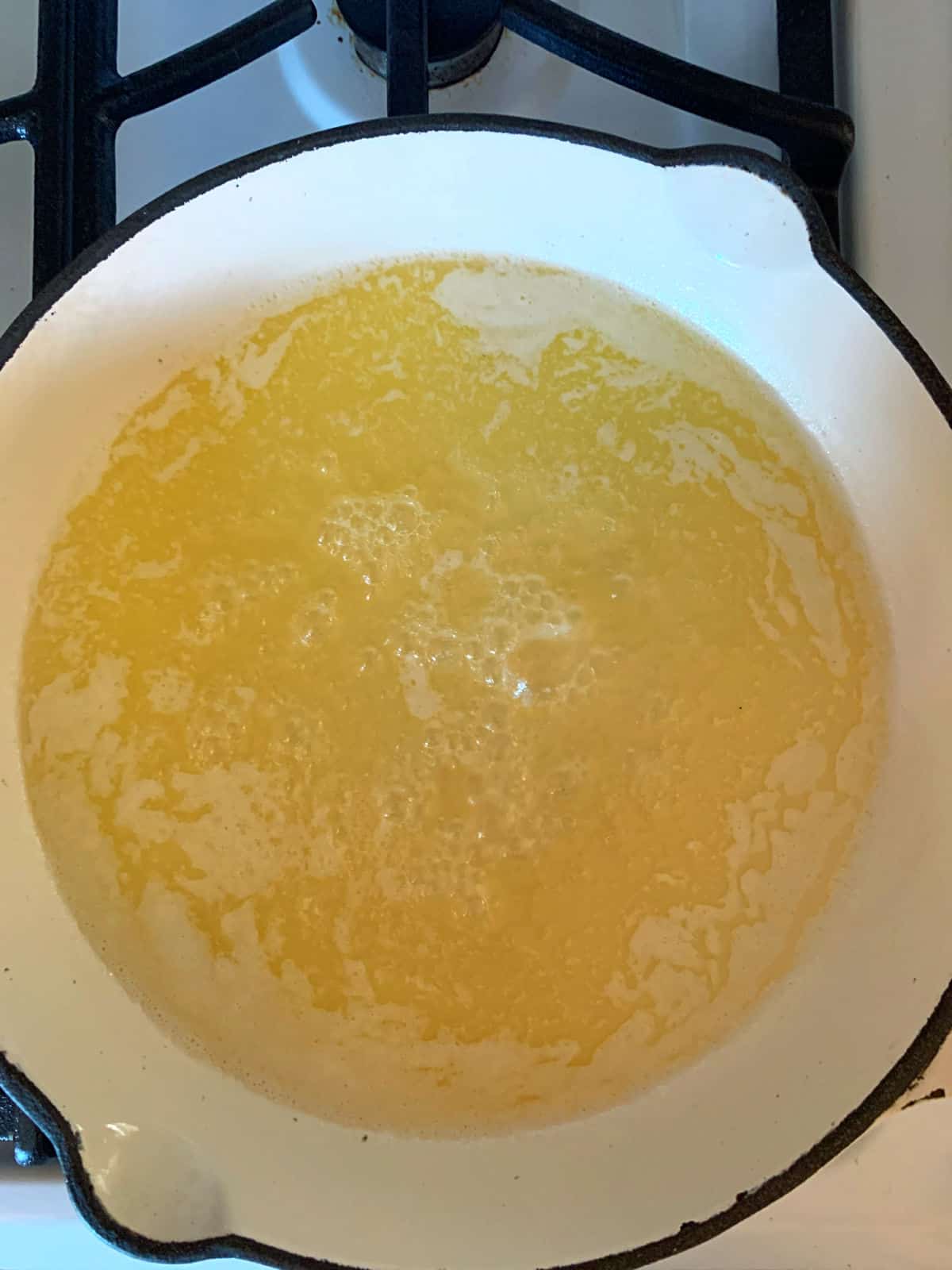 Melted butter in a white skillet.
