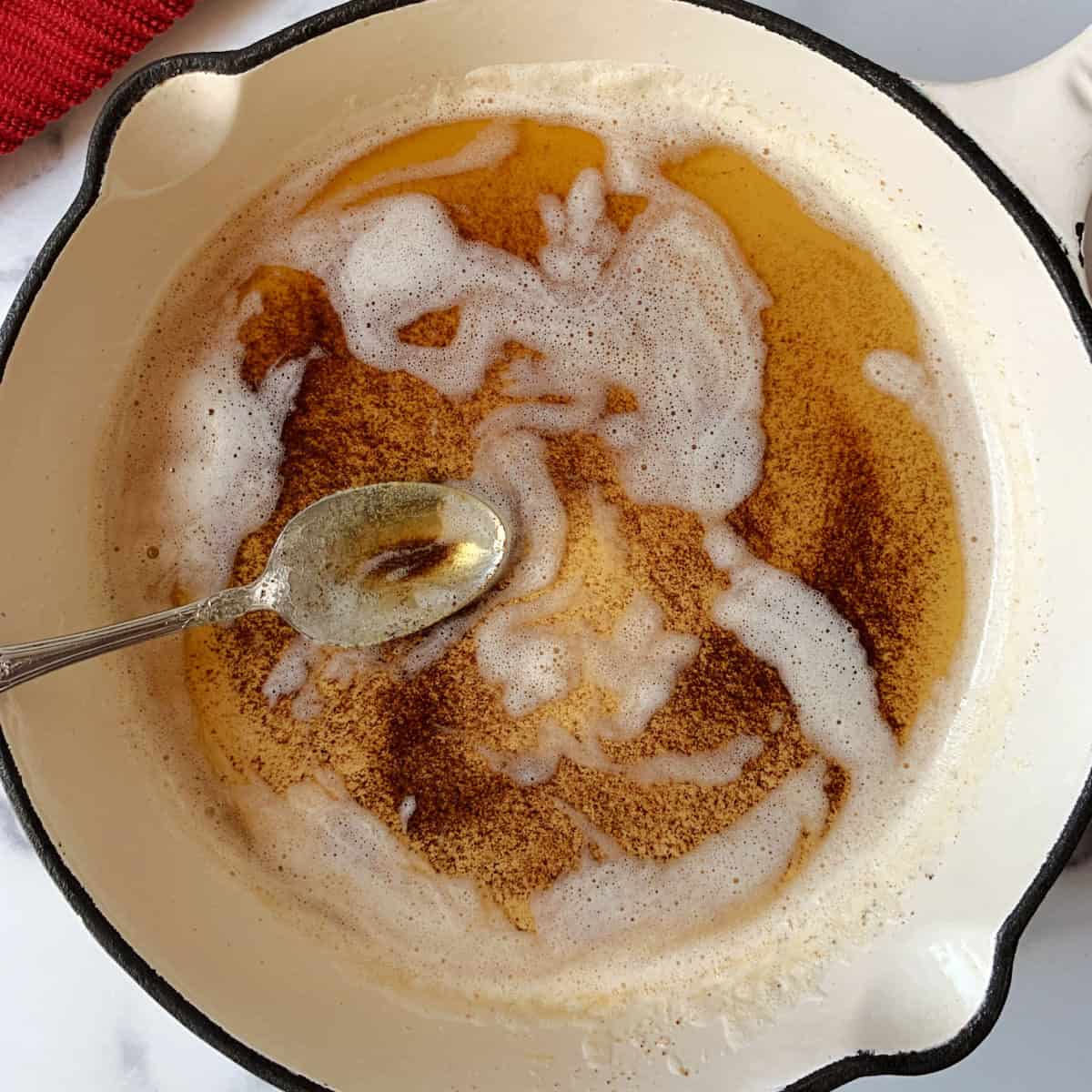 Browned butter in white skillet.