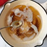 Browned butter in white skillet.