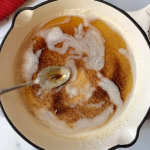 Browned butter in white skillet.