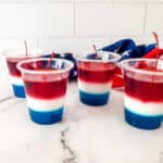 Layered jello in plastic cups.