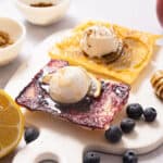 Fruit tarts with scoops of ice cream on top.