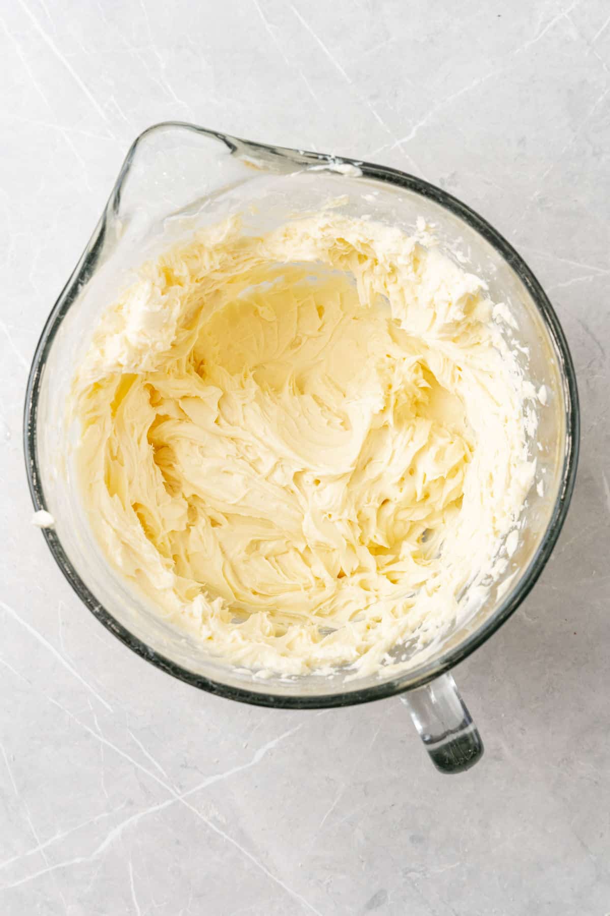 White frosting in a glass bowl.
