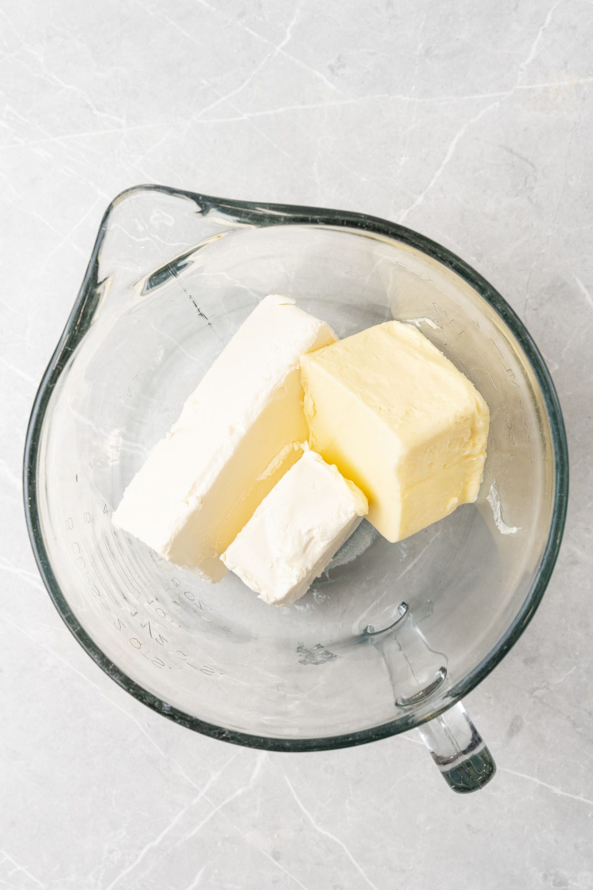 Butter and cream cheese in a glass bowl.