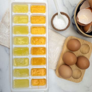 A tray with eggs yolks, egg whites and whole eggs.
