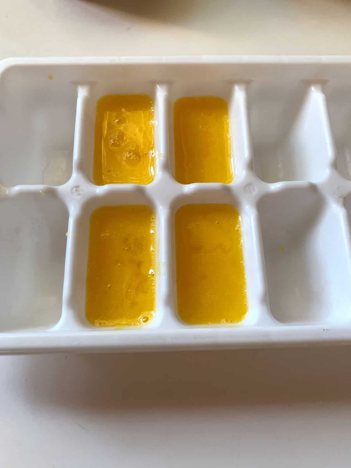 Egg yolks in an ice cube tray.