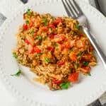 A plate with rice and hamburger on it.