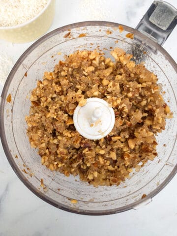 A food processor filled with ground almonds and pineapple.
