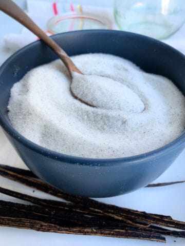 Vanilla sugar in a bowl with a spoon.