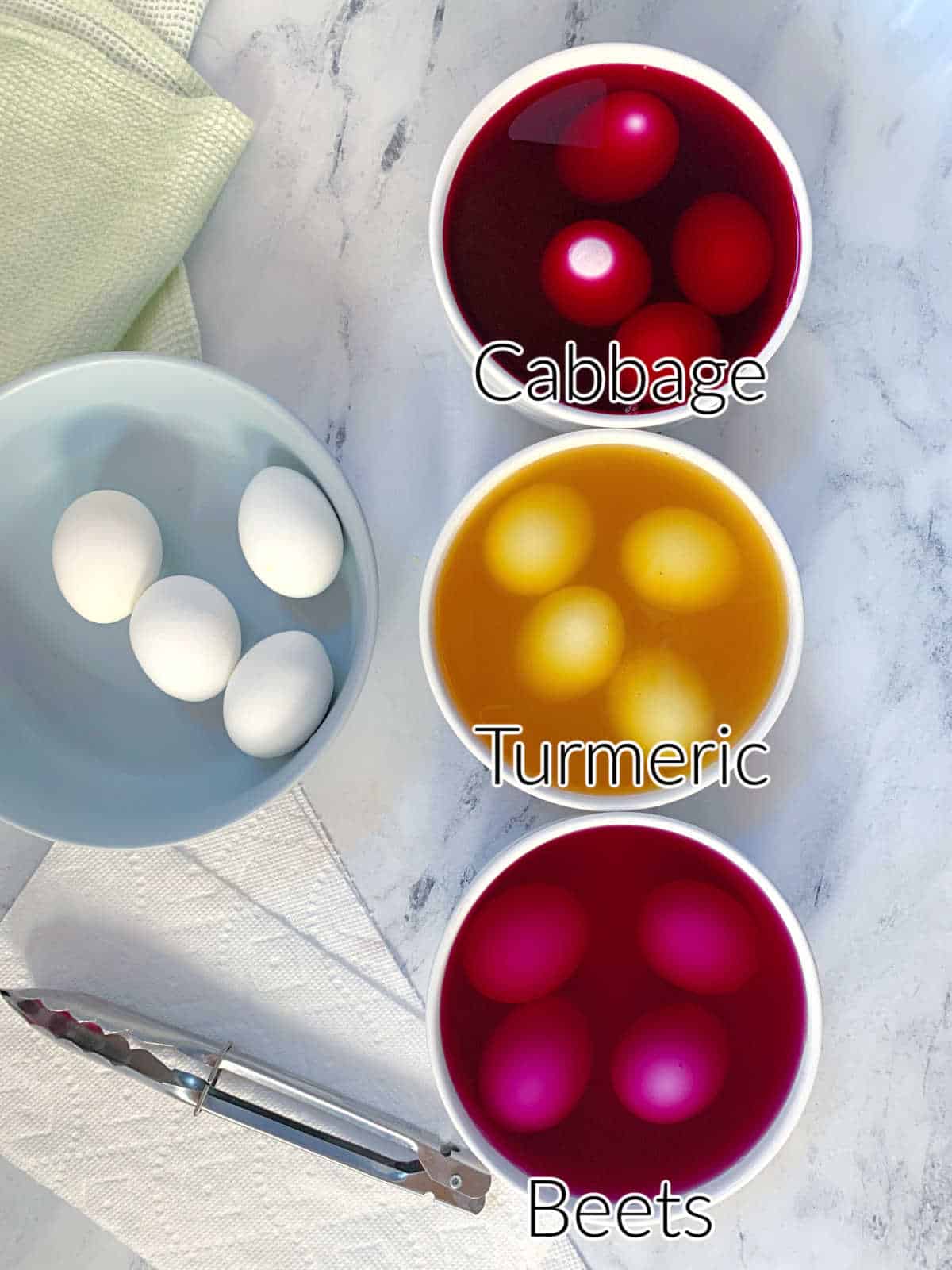 Four bowls of different colors to dye eggs with text overlay.