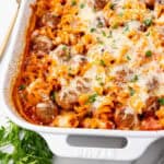 A meatball casserole in a white baking dish.