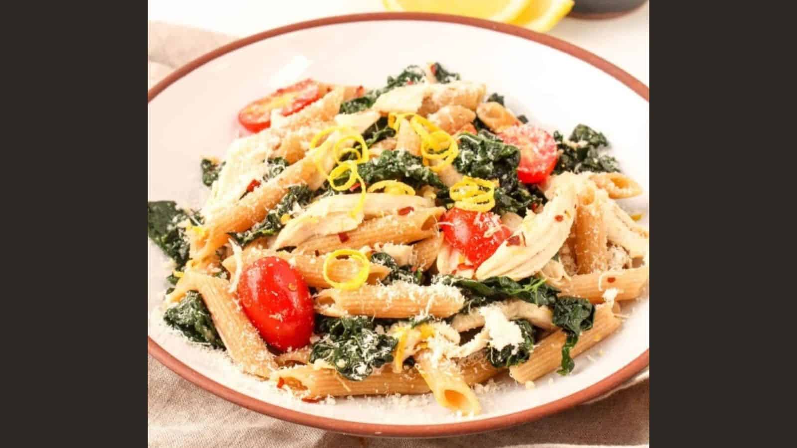 Lemon chicken pasta with kale on a plate.