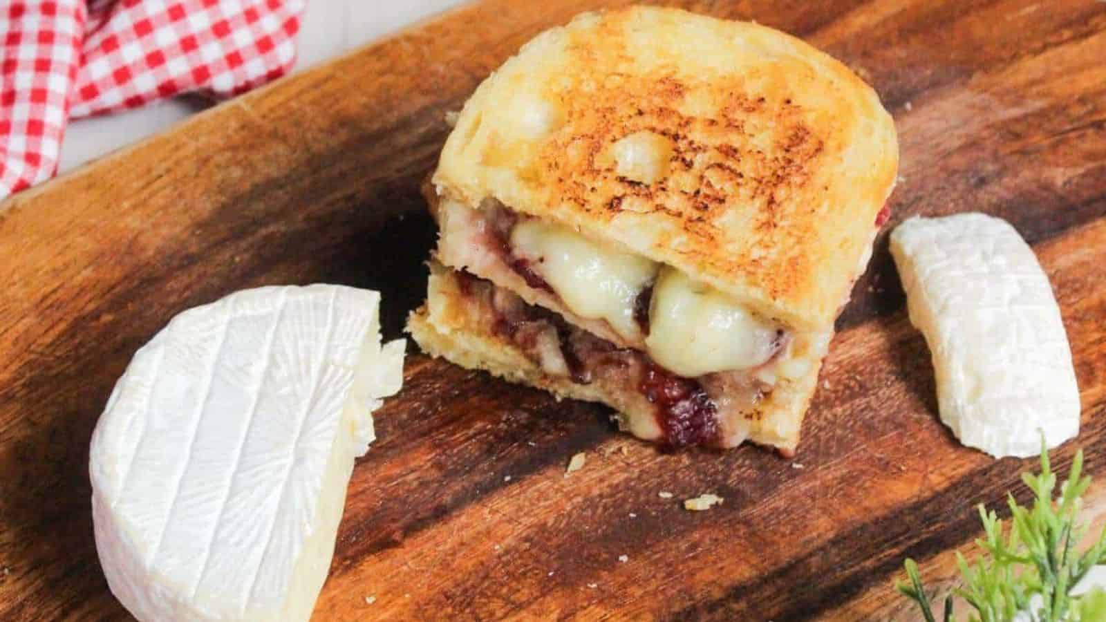 A grilled cheese sandwich on a wooden cutting board.