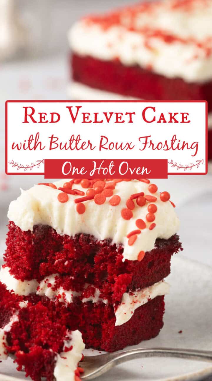 A slice of red velvet cake with white butter roux frosting and red sprinkles is served on a plate, with more cake in the background.