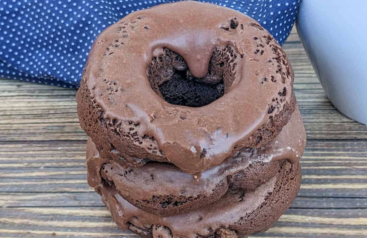 Stack of donuts on a wooden surface.