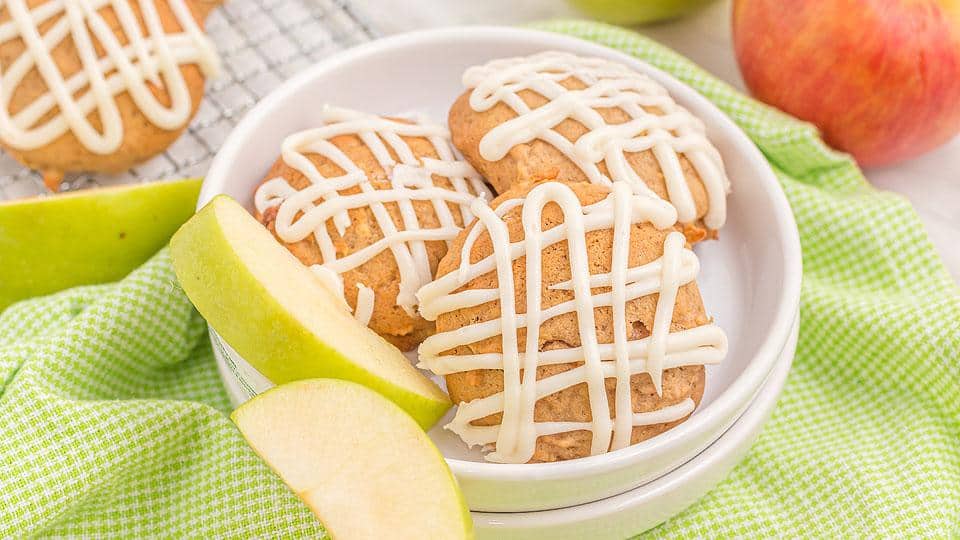 A bowl of cookies with white frosting.