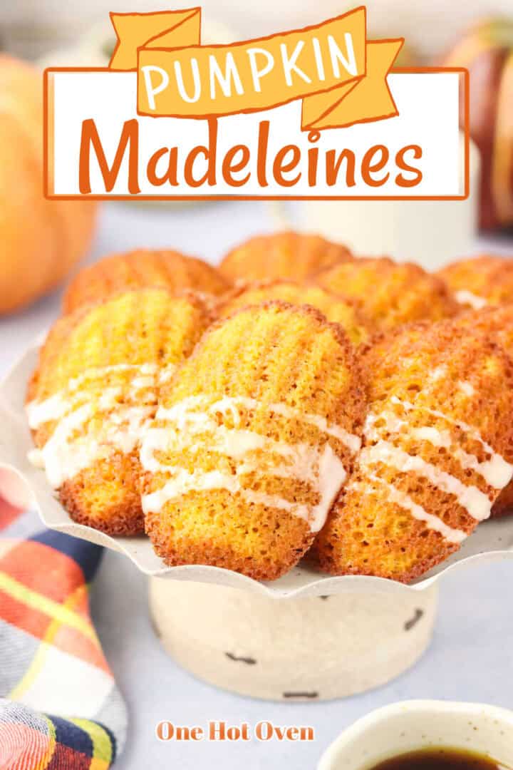 A plate of pumpkin madeleines with icing drizzle sits on a pedestal, with the text "Pumpkin Madeleines" at the top and "One Hot Oven" at the bottom.
