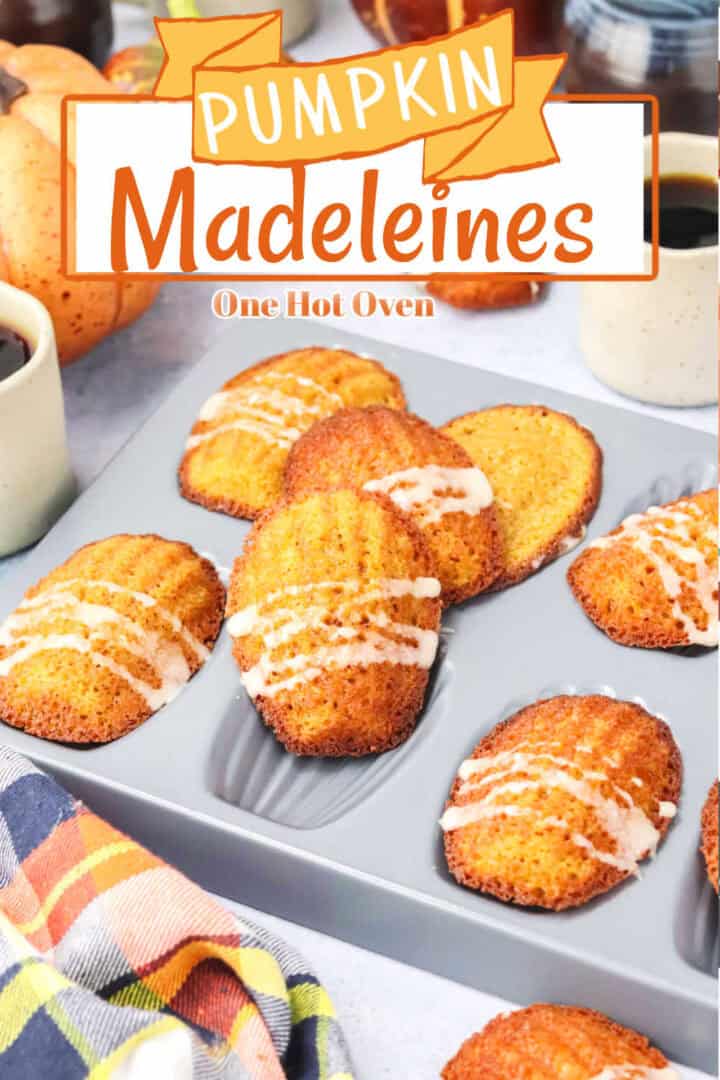 Madeleine cookies with icing are displayed in a baking tray, with a pumpkin and coffee cups nearby. Text on the image reads "Pumpkin Madeleines, One Hot Oven.