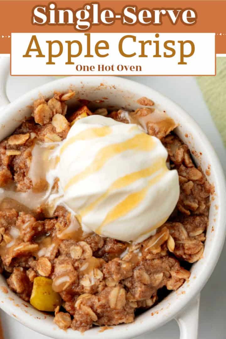 A small white bowl filled with apple crisp topped with a scoop of whipped cream and caramel drizzle, labeled “Single-Serve Apple Crisp.”.