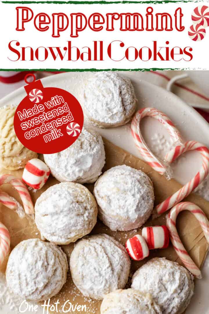 A plate of powdered sugar-covered peppermint snowball cookies surrounded by candy canes and peppermint candies; a label notes they’re made with sweetened condensed milk.