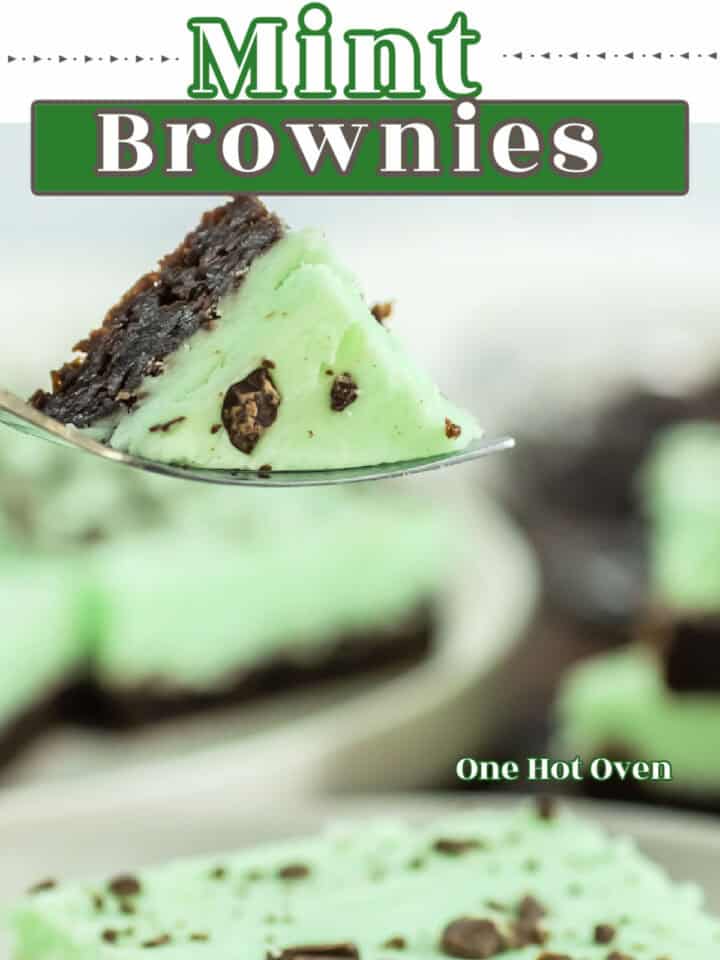 A close-up of a fork holding a piece of mint brownie with a green mint layer and chocolate brownie base; a plate of brownies is blurred in the background. Text reads "Mint Brownies.