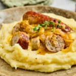A plate of Bangers and Mash with Onion gravy.