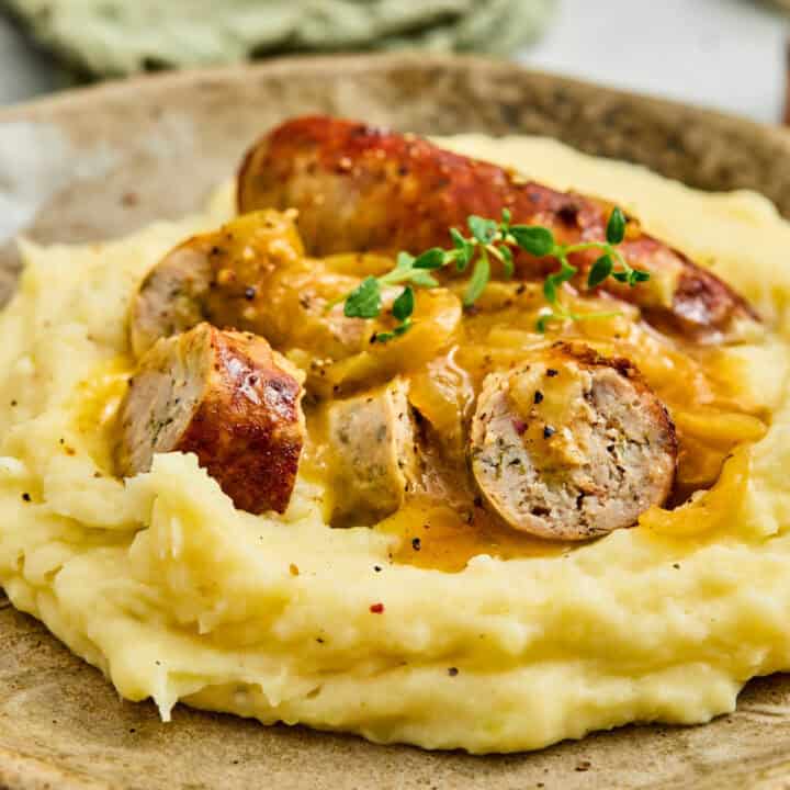 A plate of Bangers and Mash with Onion gravy.