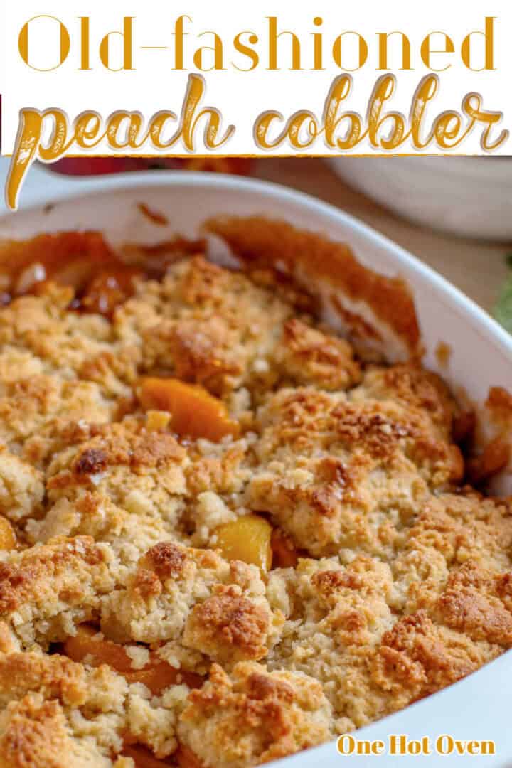Close-up of a baked peach cobbler in a white dish, topped with golden, crumbly biscuit crust. Text reads "Old-fashioned peach cobbler" and "One Hot Oven.